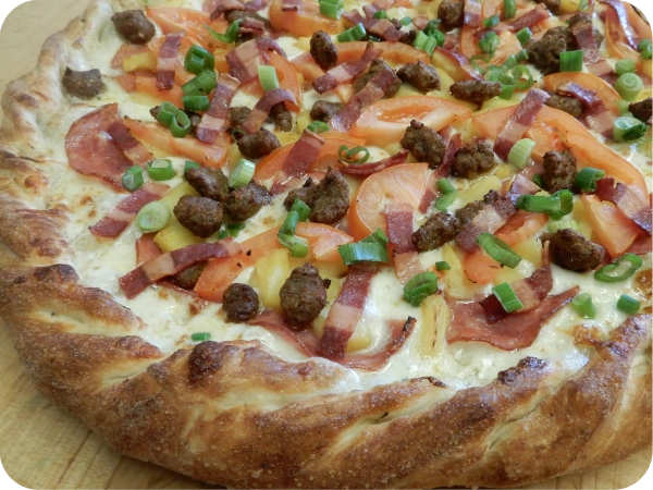Loaded pizza with ham and pineapple